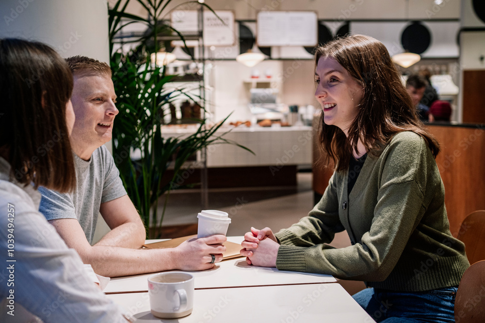 Mature woman with disability sitting with colleagues in cafe Mature woman with disability sitting with colleagues in cafe