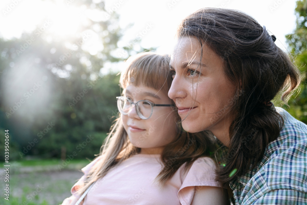 Affectionate mother spending leisure time with daughter wearing eyeglasses Affectionate mother spending leisure time with daughter wearing eyeglasses
