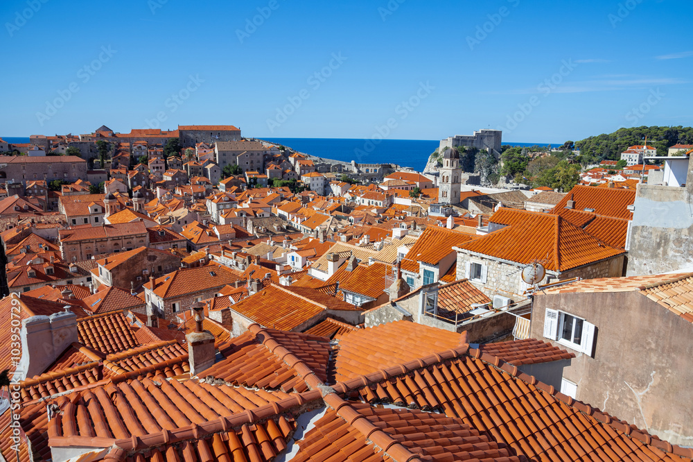 panoramic view of old town Dubrovnik, Croatia, showing terracotta rooftops, ancient architecture, the Mediterranean Sea, and ancient fortifications. Dalmatian coast. panoramic view of old town Dubrovnik, Croatia, showing terracotta rooftops, ancient architecture, the Mediterranean Sea, and ancient fortifications. Dalmatian coast.