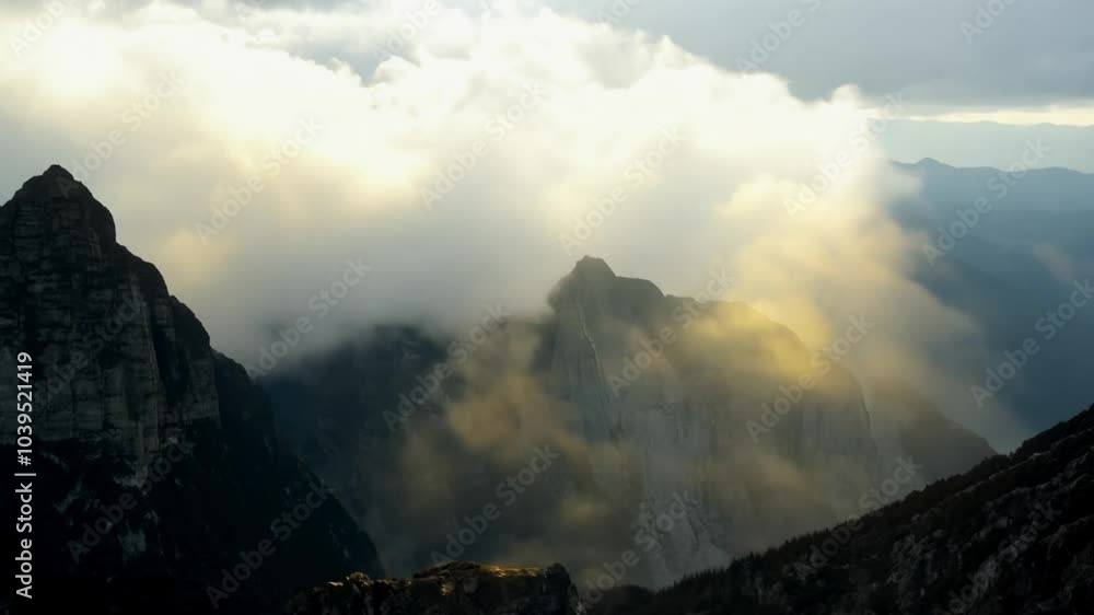 Majestic Peaks: Clouds Rolling Over Rugged Mountain Ridges Majestic Peaks: Clouds Rolling Over Rugged Mountain Ridges