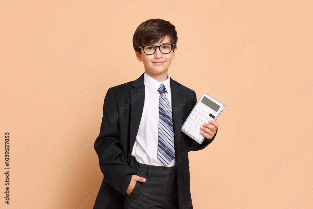 Boy with calculator pretending to be accountant on beige background. Dreaming of future profession Boy with calculator pretending to be accountant on beige background. Dreaming of future profession