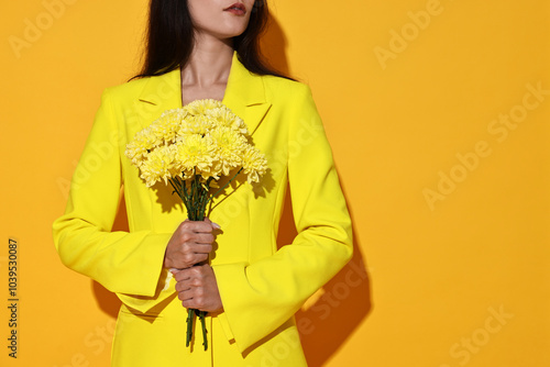 Woman with beautiful bouquet of flowers on yellow background, closeup. Space for text photo