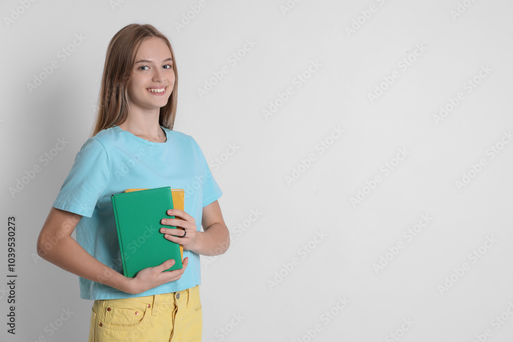 Teenage girl with books on white background, space for text Teenage girl with books on white background, space for text