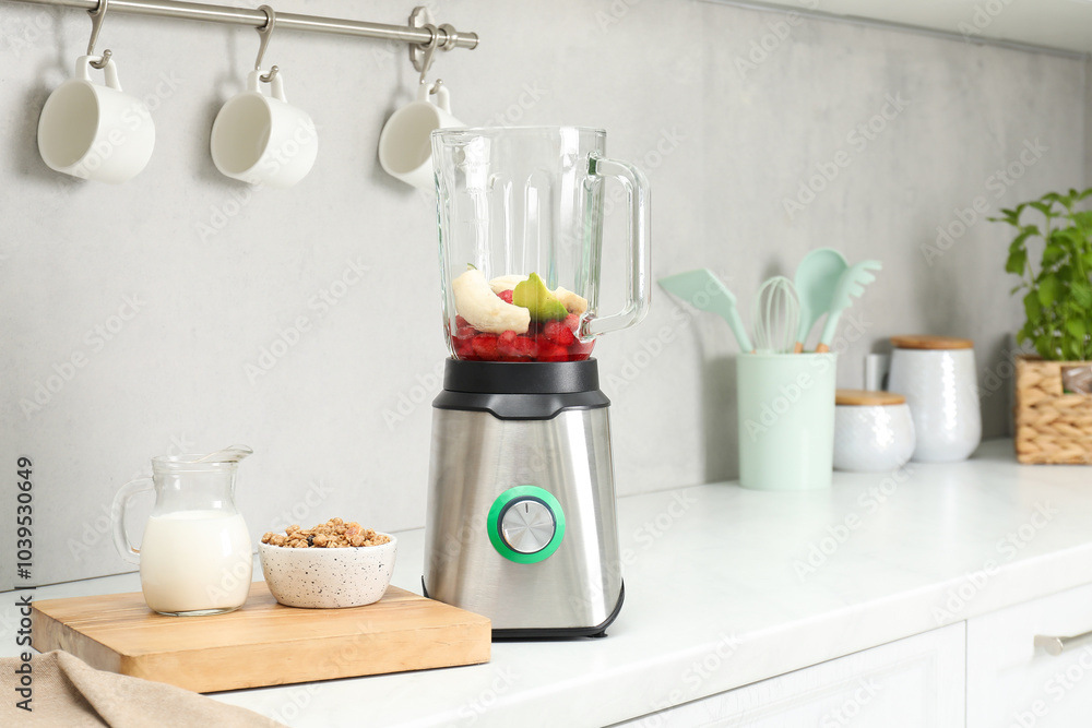 Blender and fresh ingredients on white countertop in kitchen Blender and fresh ingredients on white countertop in kitchen