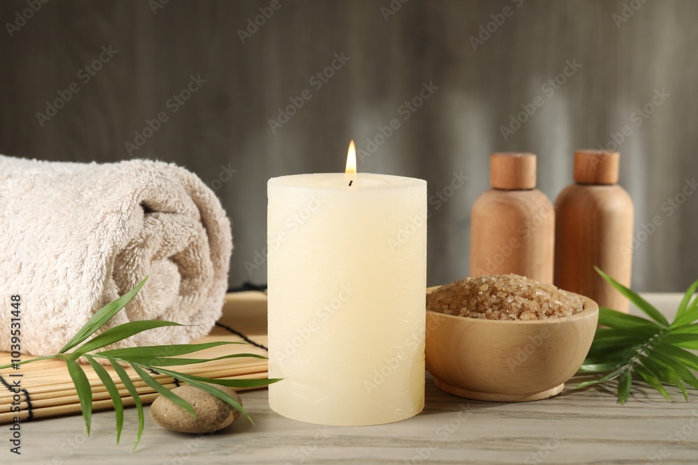Spa composition with burning candle on wooden table Spa composition with burning candle on wooden table