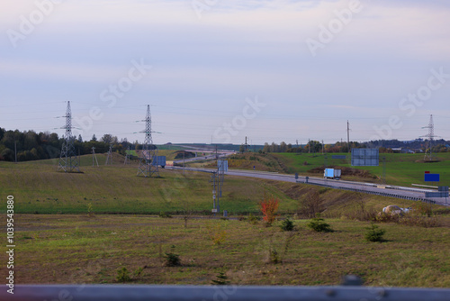 Wide road, highway, sun and blue sky on a summer day.