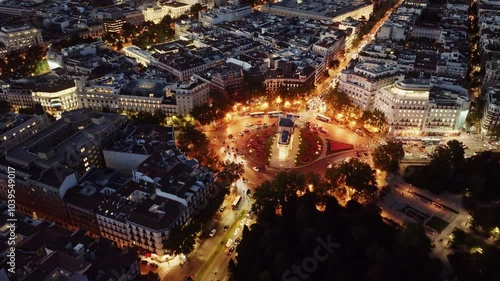 Aerial view of Madrid at night, capital of Spain, drone view of Puerta de Alcala, Puerta de la Independencia in Madrid, Spain at night with night lights. photo