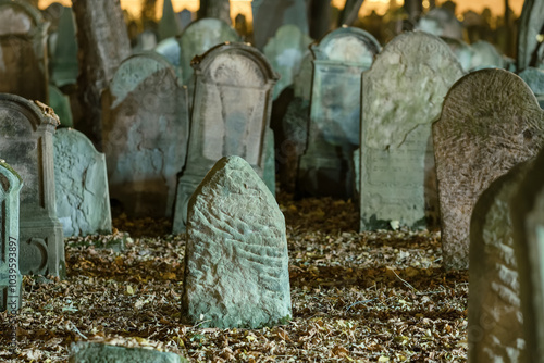 Tombstones in an old cemetery at night.