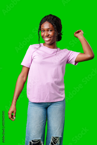 Joyful woman celebrating success with clenched fists against a bright green background