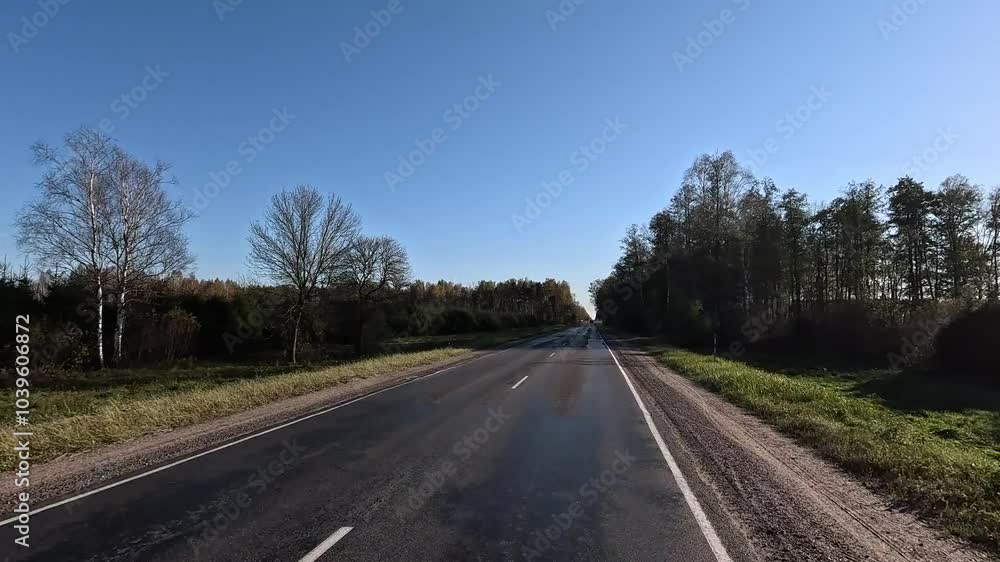 Autumn landscape and view of the road in motion. Driving a car on the road at speed. Asphalt and white road markings. Autumn landscape and view of the road in motion. Driving a car on the road at speed. Asphalt and white road markings.