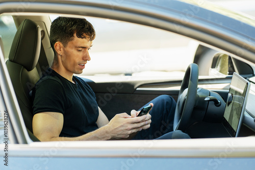 Man using smartphone while sitting in car