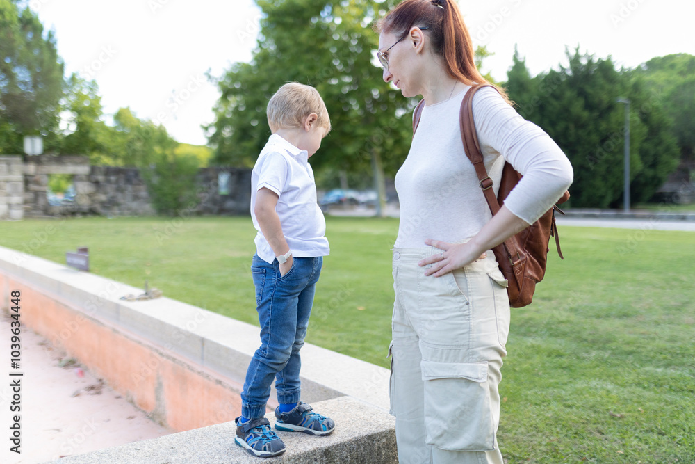 A woman and a child are standing in a park A woman and a child are standing in a park