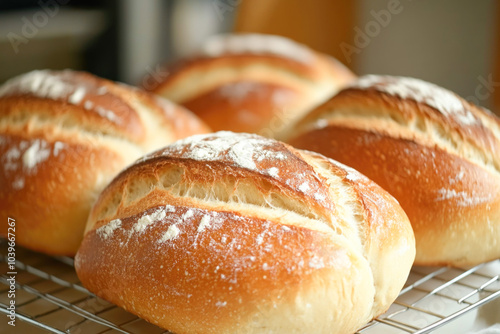 Freshly baked bread loaves cooling on rack in warm light kitchen setting photo