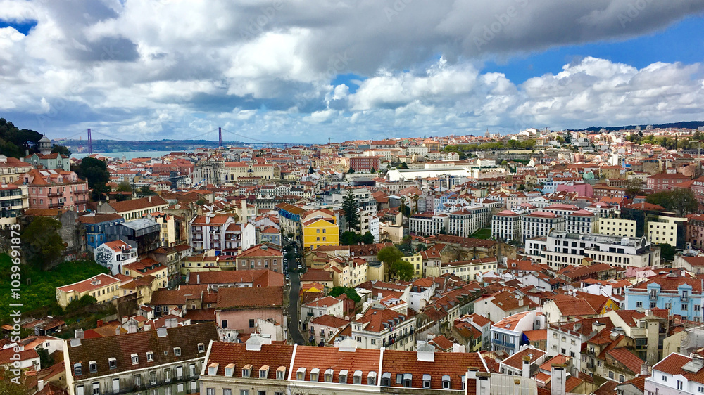 Fototapeta premium Vibrant cityscape of Lisbon, Portugal, showcasing colorful architecture under dramatic clouds, ideal for travel and tourism themes