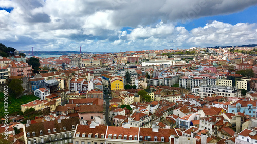 Vibrant cityscape of Lisbon, Portugal, showcasing colorful architecture under dramatic clouds, ideal for travel and tourism themes