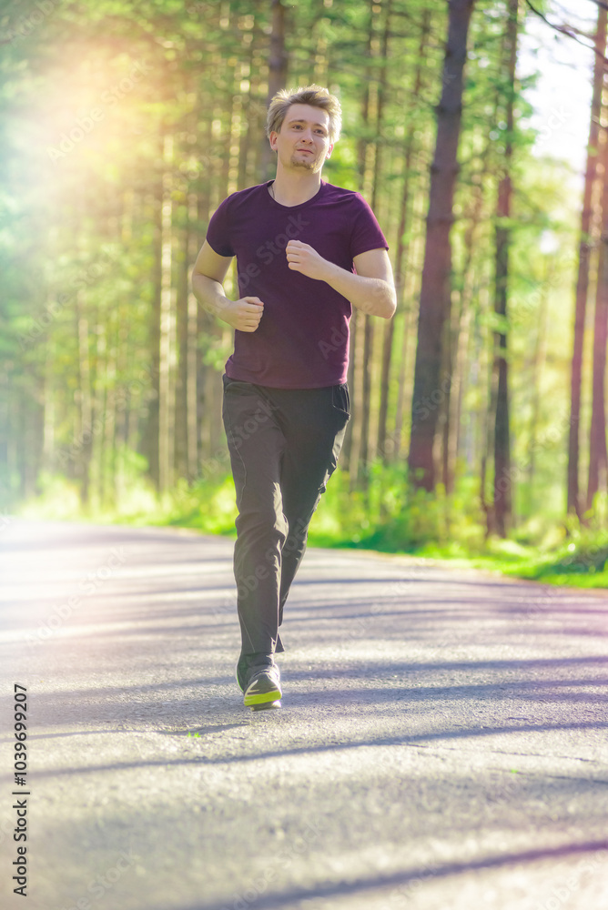 Running man jogging in city park at beautiful summer day. Sport fitness model caucasian ethnicity training outdoor. Running man jogging in city park at beautiful summer day. Sport fitness model caucasian ethnicity training outdoor.