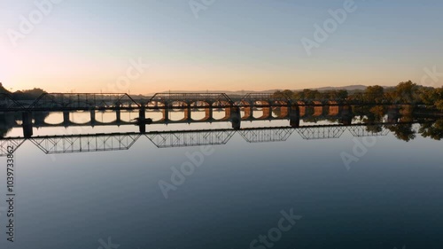 Wallpaper Mural Aerial view of multiple bridges crossing the Susquehanna River at sunrise in Harrisburg, Pennsylvania, with the city skyline and surrounding landscapes bathed in golden light. Torontodigital.ca