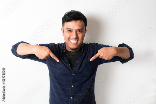 Adult Asian man smiling happy while pointing down photo