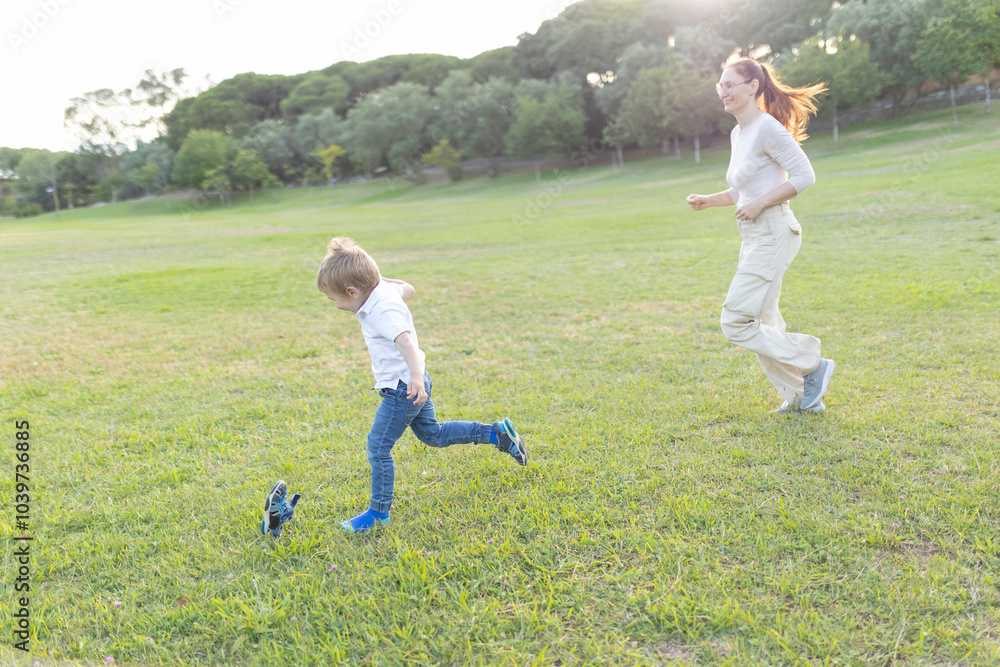 Mother and son running and playing in the park Mother and son running and playing in the park