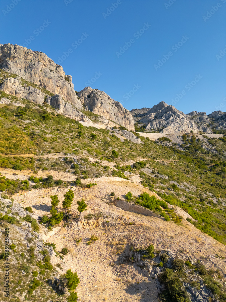 Rocky Mountain range with mountain road in the Adriatic Coast, Dalmatia, Croatia Rocky Mountain range with mountain road in the Adriatic Coast, Dalmatia, Croatia