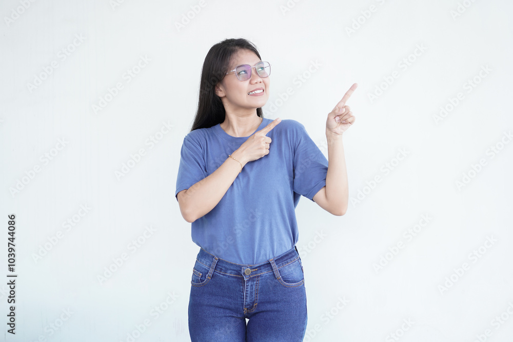 Beautiful Asian woman smiles while pointing to the side copy space, perfect for advertising or promotions on a white background Beautiful Asian woman smiles while pointing to the side copy space, perfect for advertising or promotions on a white background