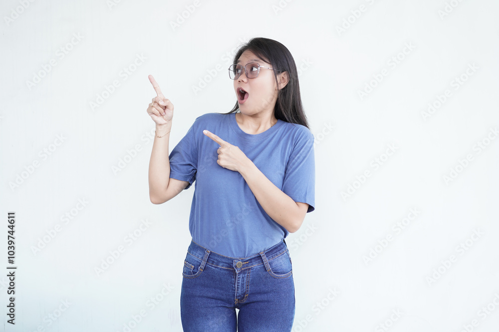 Beautiful Asian woman looks shocked, with a 'wow' expression, pointing to the side with her forefinger
