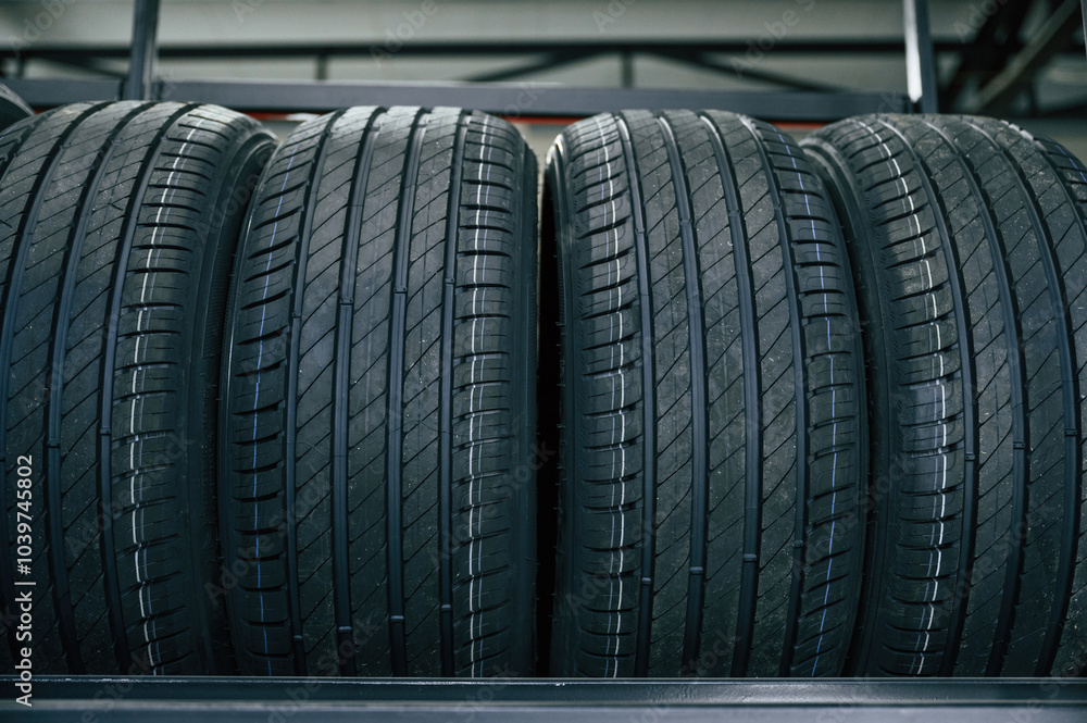In the right order. New tires are placed on the storage rack in the car workshop In the right order. New tires are placed on the storage rack in the car workshop
