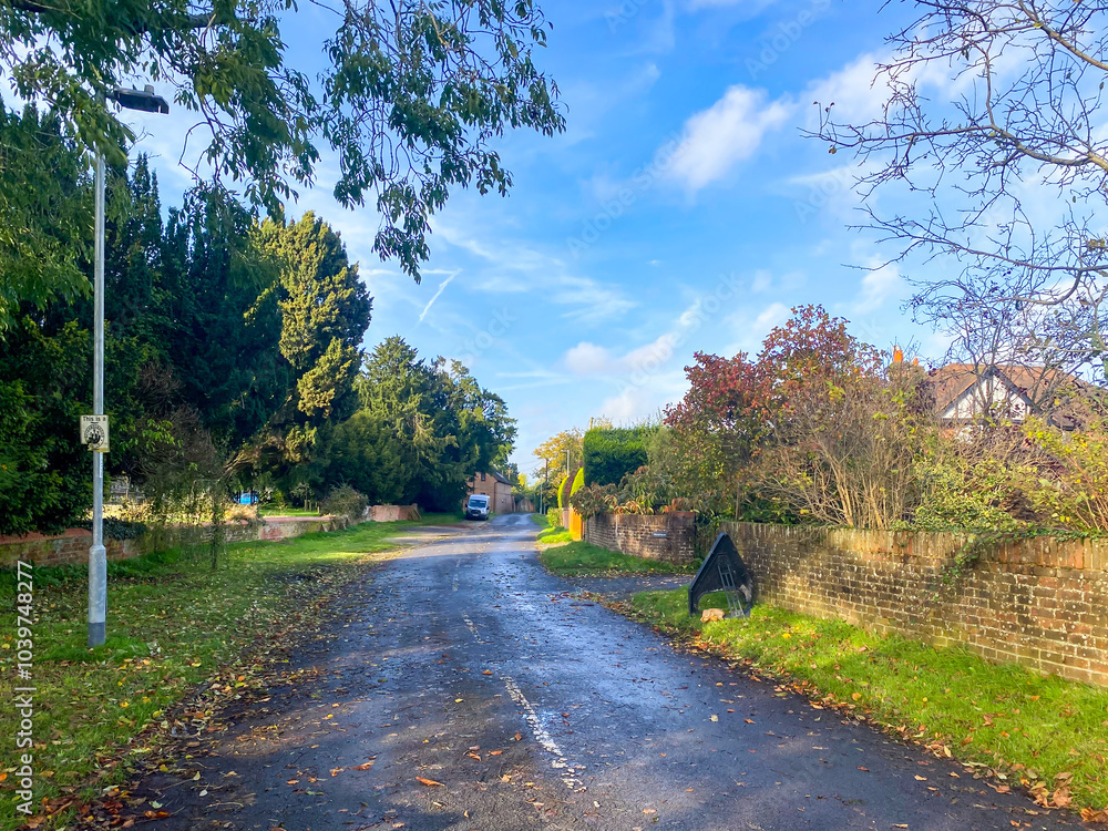 Obraz premium A view down Routh Lane, a residential street in Tilehurst in the suburbs of Reading, Berkshire, UK