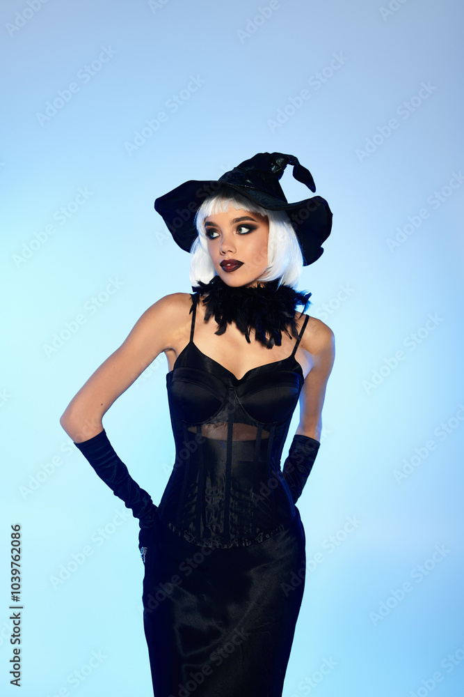 A young beautiful woman showcases her Halloween witch outfit with confidence and elegance. A young beautiful woman showcases her Halloween witch outfit with confidence and elegance.