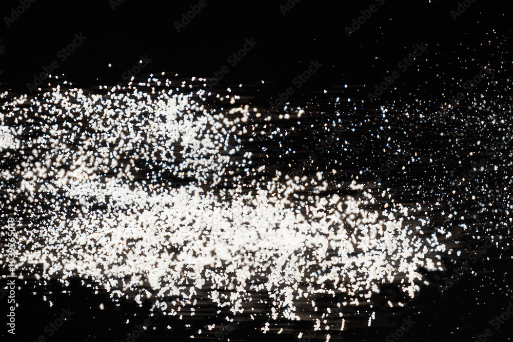 Abstract black and white background of pouring flour, space for text Abstract black and white background of pouring flour, space for text