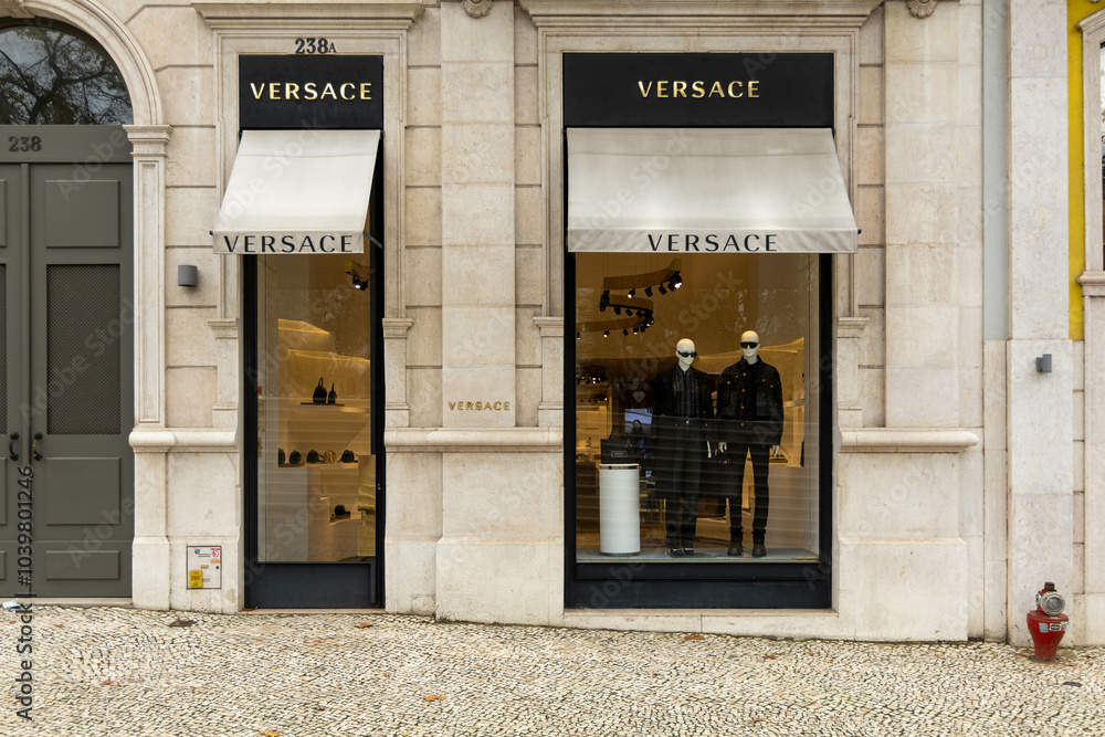 Versace letters logo above the shop window on black background. Versace ...