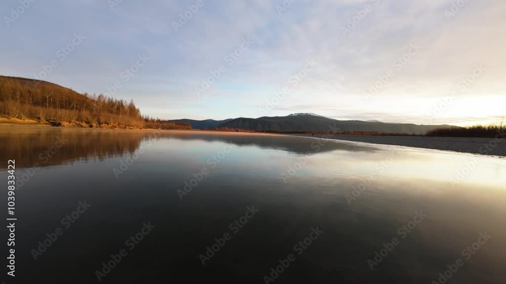 Soar high above Yakutia's stunning terrain as the sun sets, illuminating tranquil waters and majestic mountains. Soar high above Yakutia's stunning terrain as the sun sets, illuminating tranquil waters and majestic mountains.