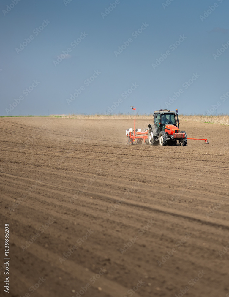 Obraz premium Tractor and seeder for sowing corn