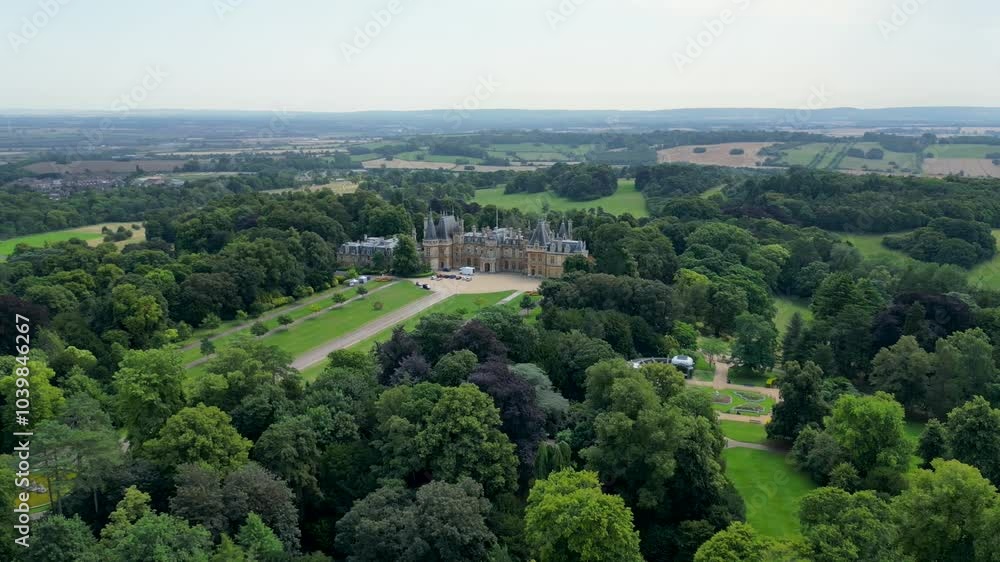 Drone shot of Waddesdon Manor on top of a hill surrounded by green, forests in Buckinghamshire, UK Drone shot of Waddesdon Manor on top of a hill surrounded by green, forests in Buckinghamshire, UK