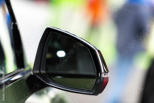 Closeup shot of the sidemirror of a modern car against a bright blur background photo