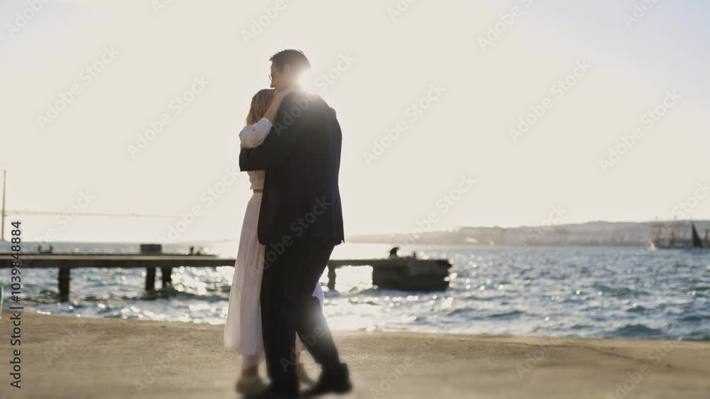 Couple performing romantic dance by the sea Couple performing romantic dance by the sea