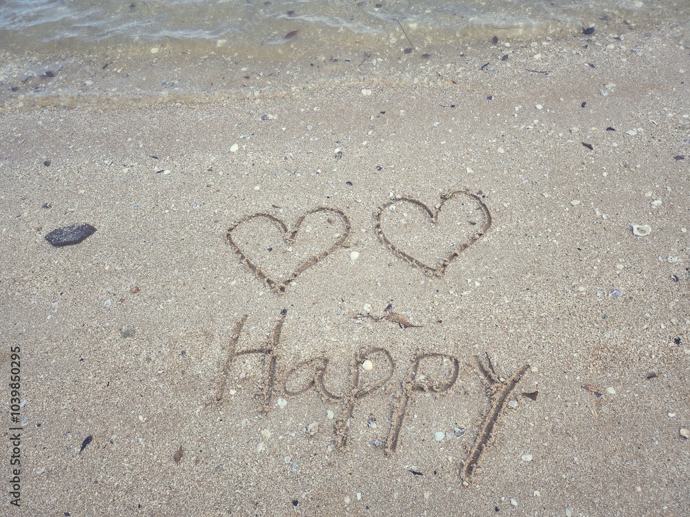 Fototapeta premium Two hearts drawn on sand beach