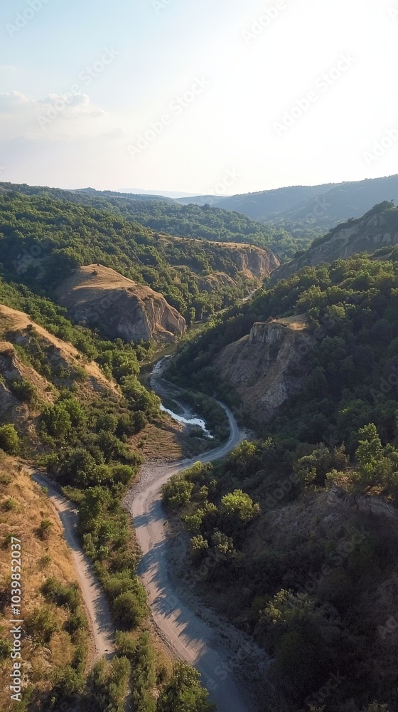 Winding river meanders through lush green hills at sunset in a tranquil rural landscape Winding river meanders through lush green hills at sunset in a tranquil rural landscape