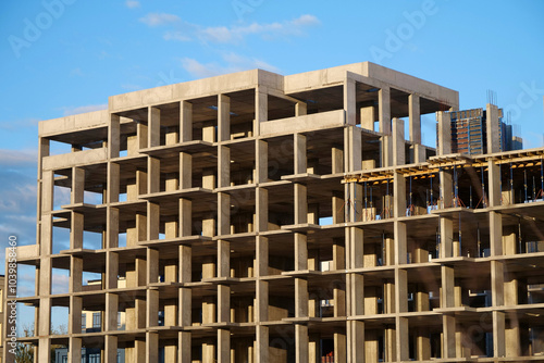 Frame of unfinished concrete construction of house, cast concrete structure photo