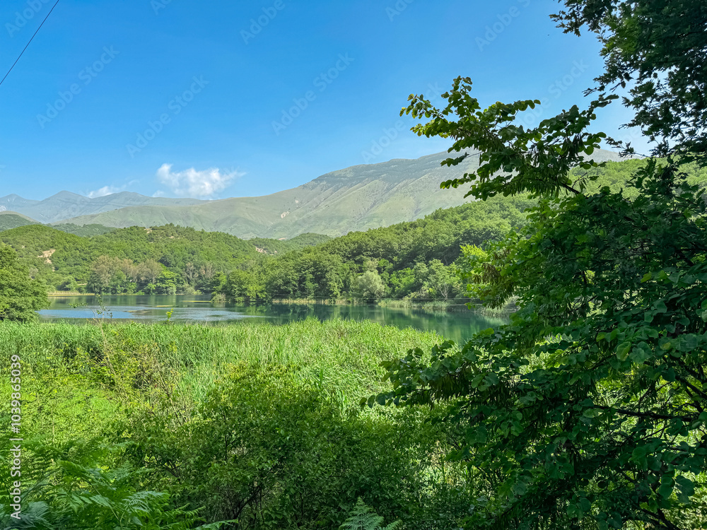 Unique water spring and natural phenomenon Blue Eye (Syri i Kalter) in Muzine, Albania. Bottomless crystal-clear blue lake surrounded by lush greenery and mountains. Peaceful enchanting atmosphere Unique water spring and natural phenomenon Blue Eye (Syri i Kalter) in Muzine, Albania. Bottomless crystal-clear blue lake surrounded by lush greenery and mountains. Peaceful enchanting atmosphere