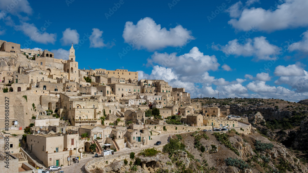 Exploring the stunning ancient architecture of Matera in Puglia, Italy under bright blue skies Exploring the stunning ancient architecture of Matera in Puglia, Italy under bright blue skies