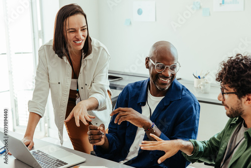 Photos Diverse co-workers in a collaborative discussion during an office meeting
