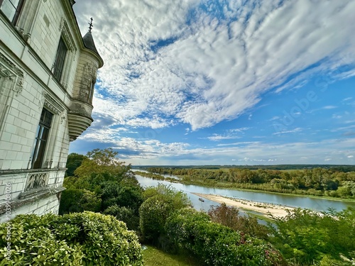 Stunning View from Chaumont-sur-Loire Castle Overlooking the Serene Loire River and Verdant Landscape Under a Beautiful Cloudy Sky photo