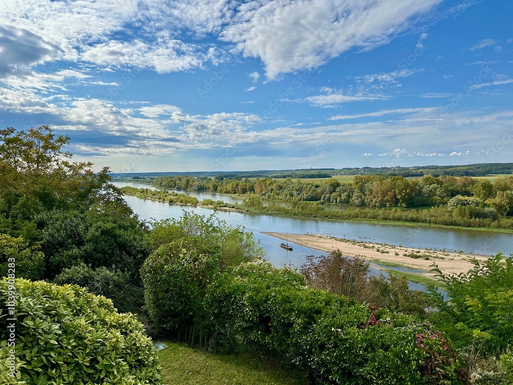 Idyllic View of the Loire River Flowing Through Verdant Landscapes with Dense Greenery Under a Beautiful Blue Sky at Chaumont-sur-Loire Idyllic View of the Loire River Flowing Through Verdant Landscapes with Dense Greenery Under a Beautiful Blue Sky at Chaumont-sur-Loire