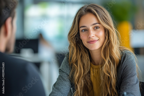 Wallpaper Mural Young woman smiles during a conversation in a modern office setting Torontodigital.ca