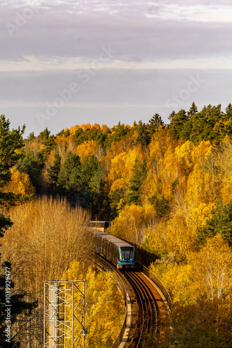 Stockholm, Sweden  A view of the Tunnelbana train or subway on the Blue Line in the Kista district  in the autumn foliage.