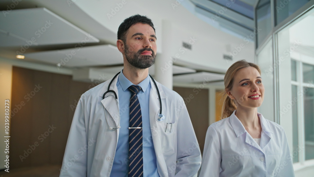 Smiling doctors walk together in modern clinic. Closeup Healthcare professionals Smiling doctors walk together in modern clinic. Closeup Healthcare professionals