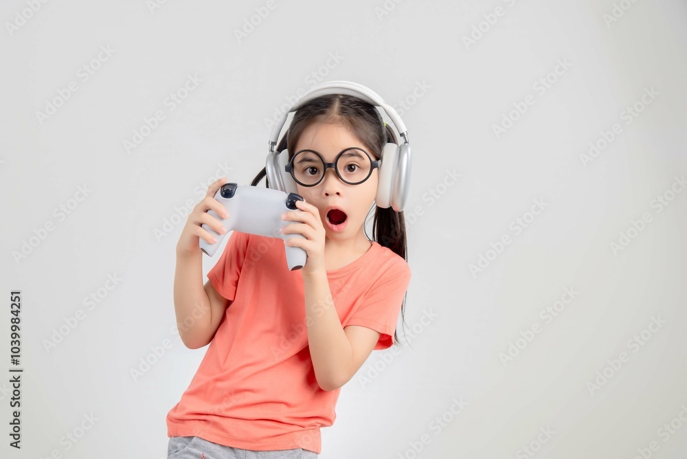 Asian happy portrait young kid girl smile lifestyle games technology holding joystick game playing on hands studio shot isolated white background with copy space. Asian happy portrait young kid girl smile lifestyle games technology holding joystick game playing on hands studio shot isolated white background with copy space.