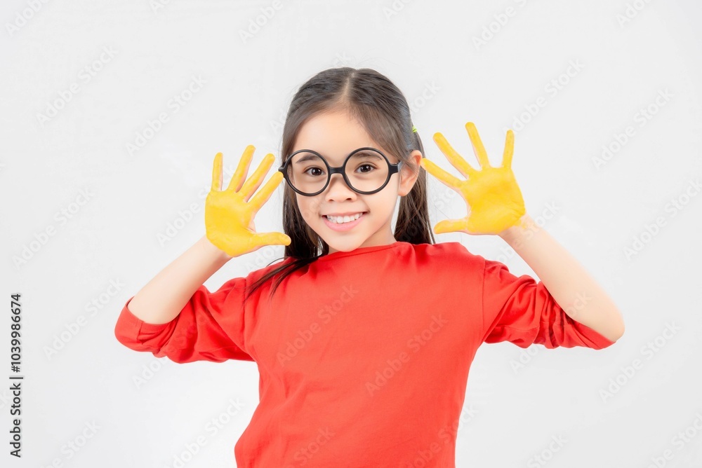 Little girl with hands painted in colorful paint. Little girl with hands painted in colorful paint.