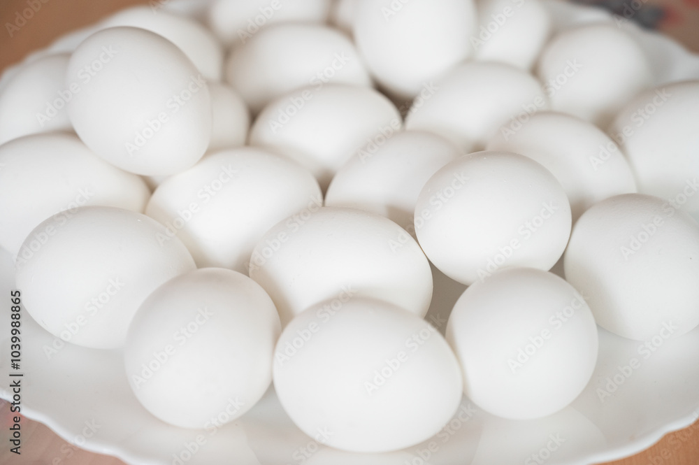 Easter themed photo with white eggs on a white plate Easter themed photo with white eggs on a white plate
